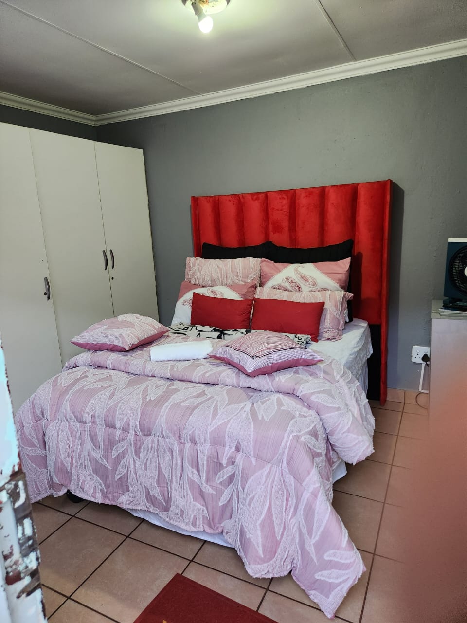 Room with red headboard